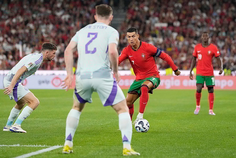 | Photo: AP/Armando Franca : 2024–25 UEFA Nations League, Portugal vs Scotland: Portugal's Cristiano Ronaldo, centre right, controls the ball